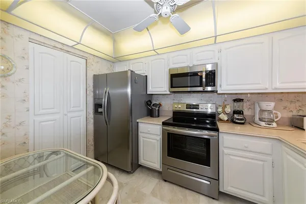 a kitchen with a stove a refrigerator and a sink