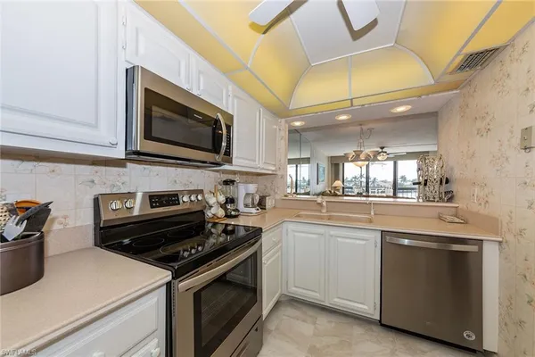 a kitchen with stainless steel appliances granite countertop a stove and a microwave