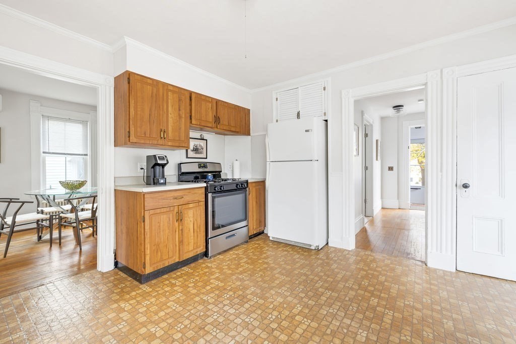 51 Denmark Avenue Milton, MA 02186 - Photo 5 of 18 a kitchen with white cabinets and stainless steel appliances