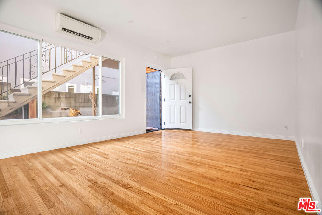1844 18th Street, Unit A Santa Monica, CA 90404 - Photo 3 of 11 a view of an empty room with wooden floor and windows