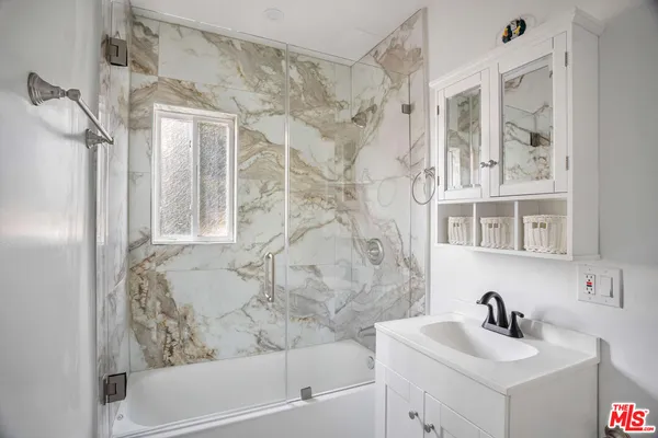 a bathroom with a bathtub and a sink