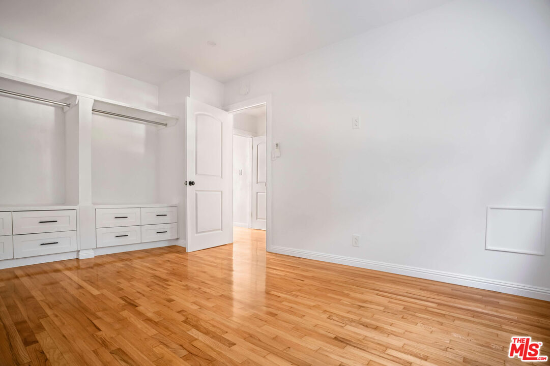1844 18th Street, Unit A Santa Monica, CA 90404 - Photo 9 of 11 an empty room with cabinet and wooden floor