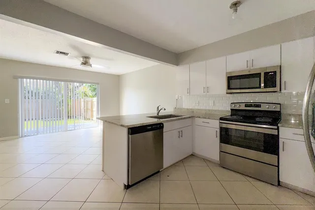a kitchen with stainless steel appliances granite countertop a stove and a sink