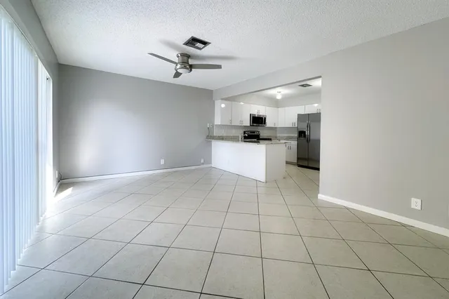 a view of a kitchen with a sink cabinets and appliances