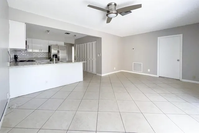 a view of a kitchen with a sink and a refrigerator