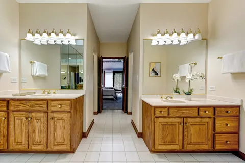 a spacious bathroom with a double vanity sink and a mirror