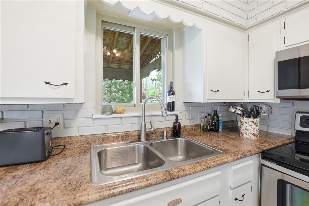 150 Littlejohn Road Troy, OH 45373 - Photo 14 of 40 This bright kitchen features a double basin sink and ample counter space with a window view.