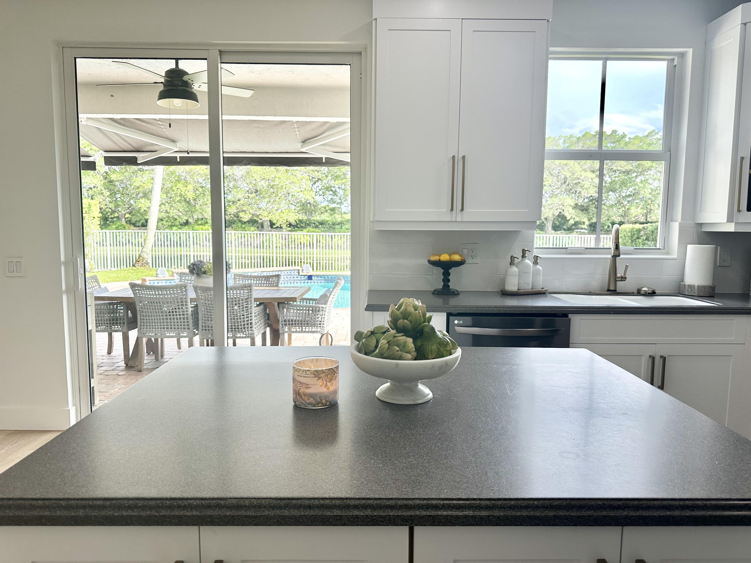 4299 Laurel Ridge Circle Weston, FL 33331 - Photo 32 of 103 a kitchen with a large window appliances and cabinets