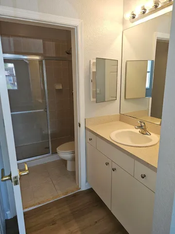 a bathroom with a sink toilet and shower
