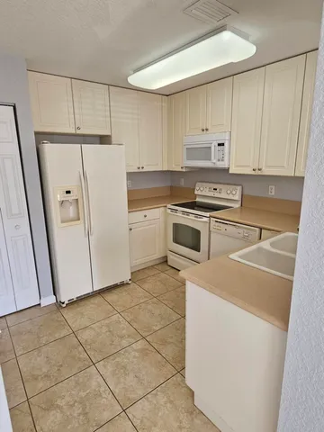 a kitchen with cabinets and white appliances