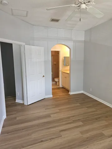 a view of a room with wooden floor and white doors