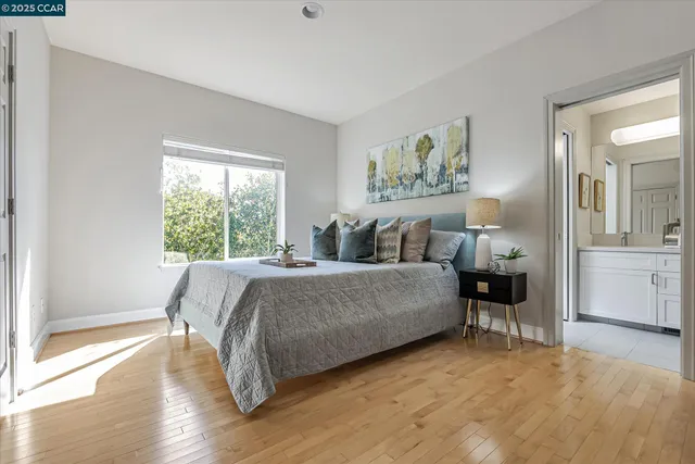 a bed room with a bed and a painting on the wall