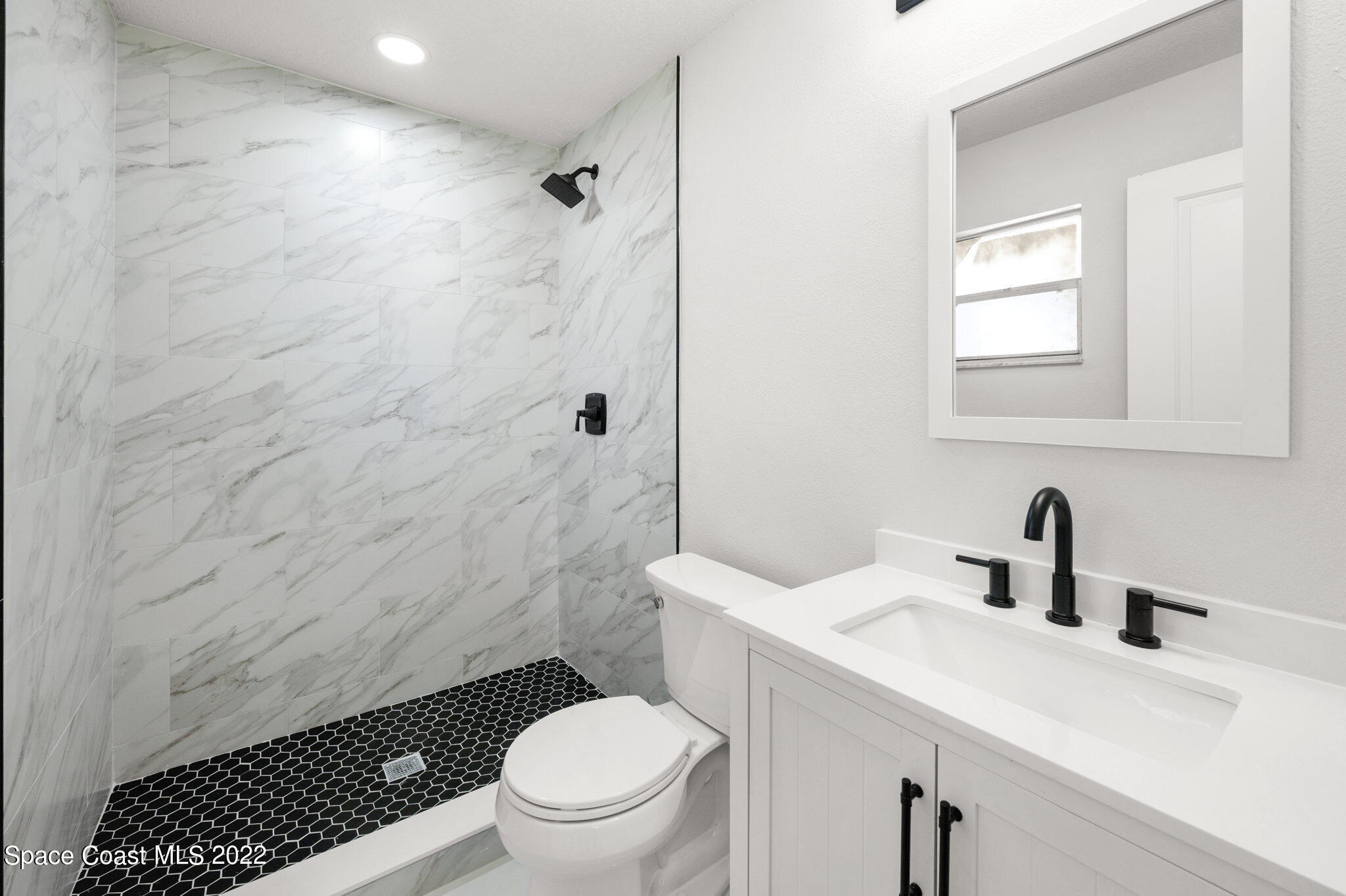 2856 Lancaster Road Melbourne, FL 32935 - Photo 12 of 22 a bathroom with a sink toilet and shower
