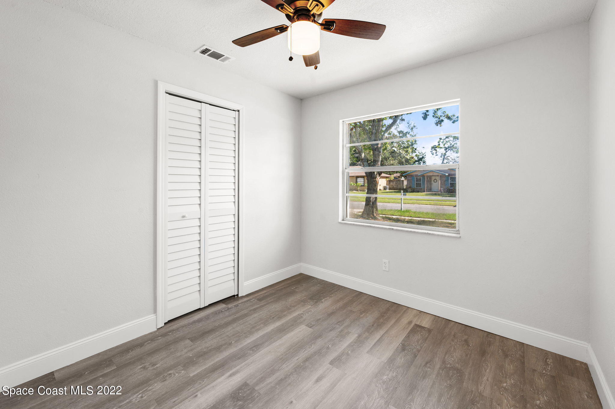 2856 Lancaster Road Melbourne, FL 32935 - Photo 15 of 22 an empty room with windows and fan