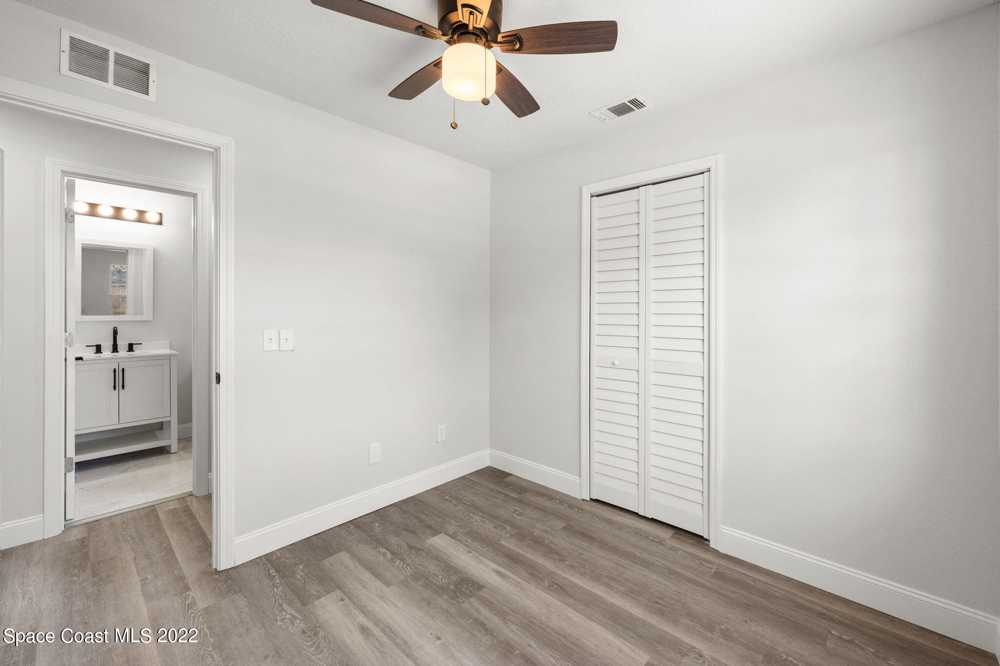 2856 Lancaster Road Melbourne, FL 32935 - Photo 16 of 22 wooden floor in an empty room with a window