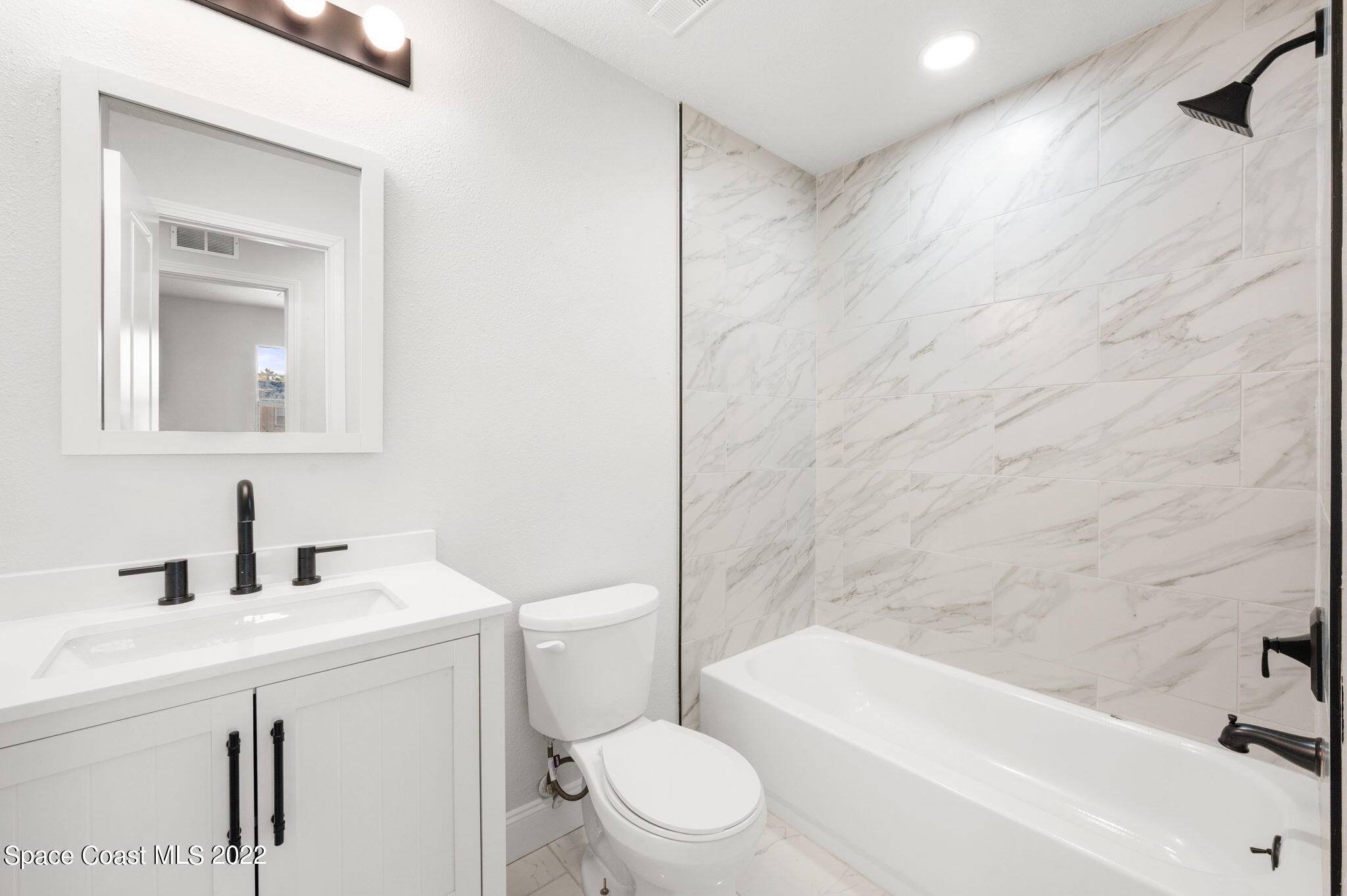 2856 Lancaster Road Melbourne, FL 32935 - Photo 17 of 22 a bathroom with a sink a toilet and a bathtub