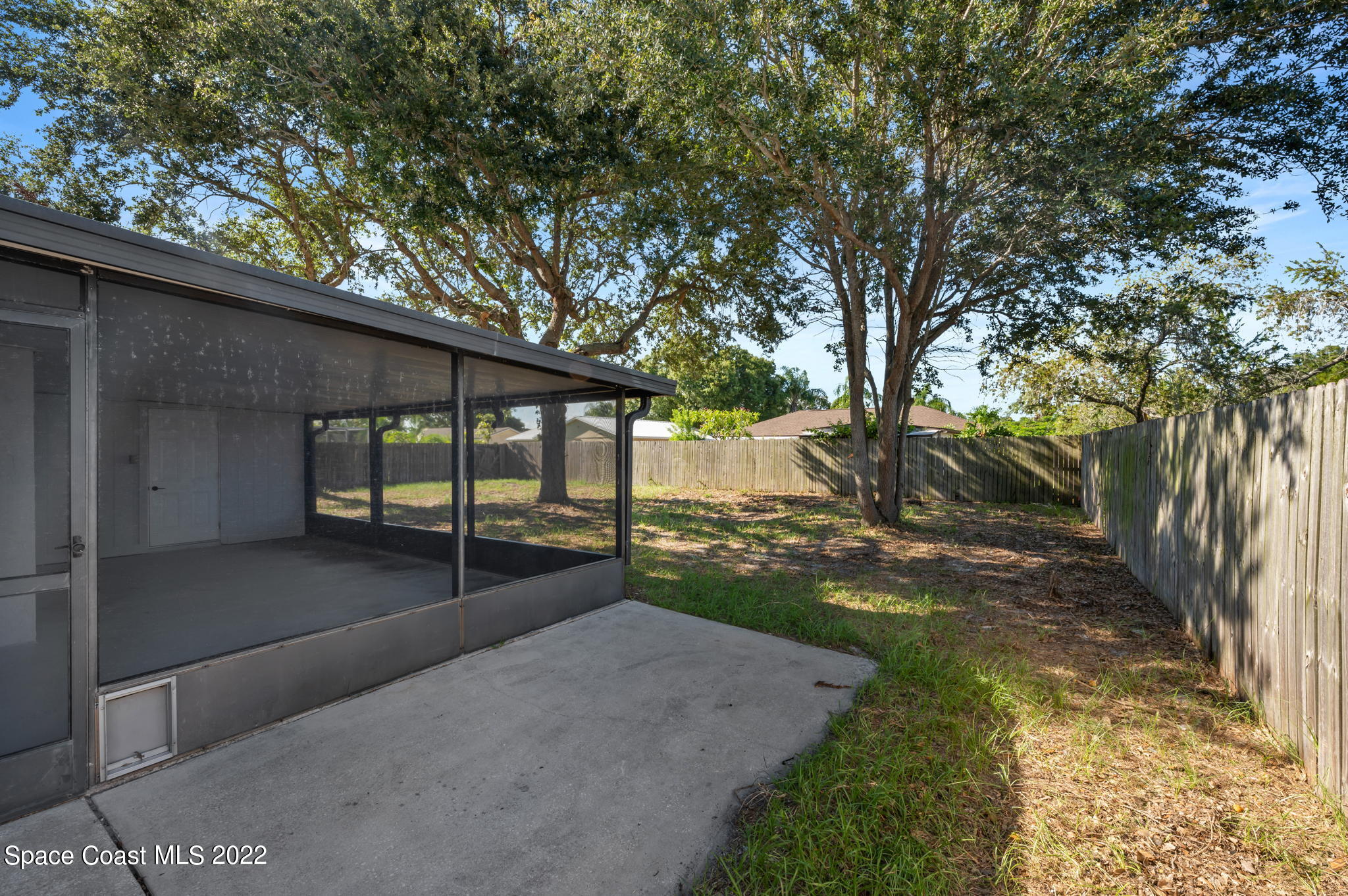 2856 Lancaster Road Melbourne, FL 32935 - Photo 20 of 22 a view of a yard with wooden fence