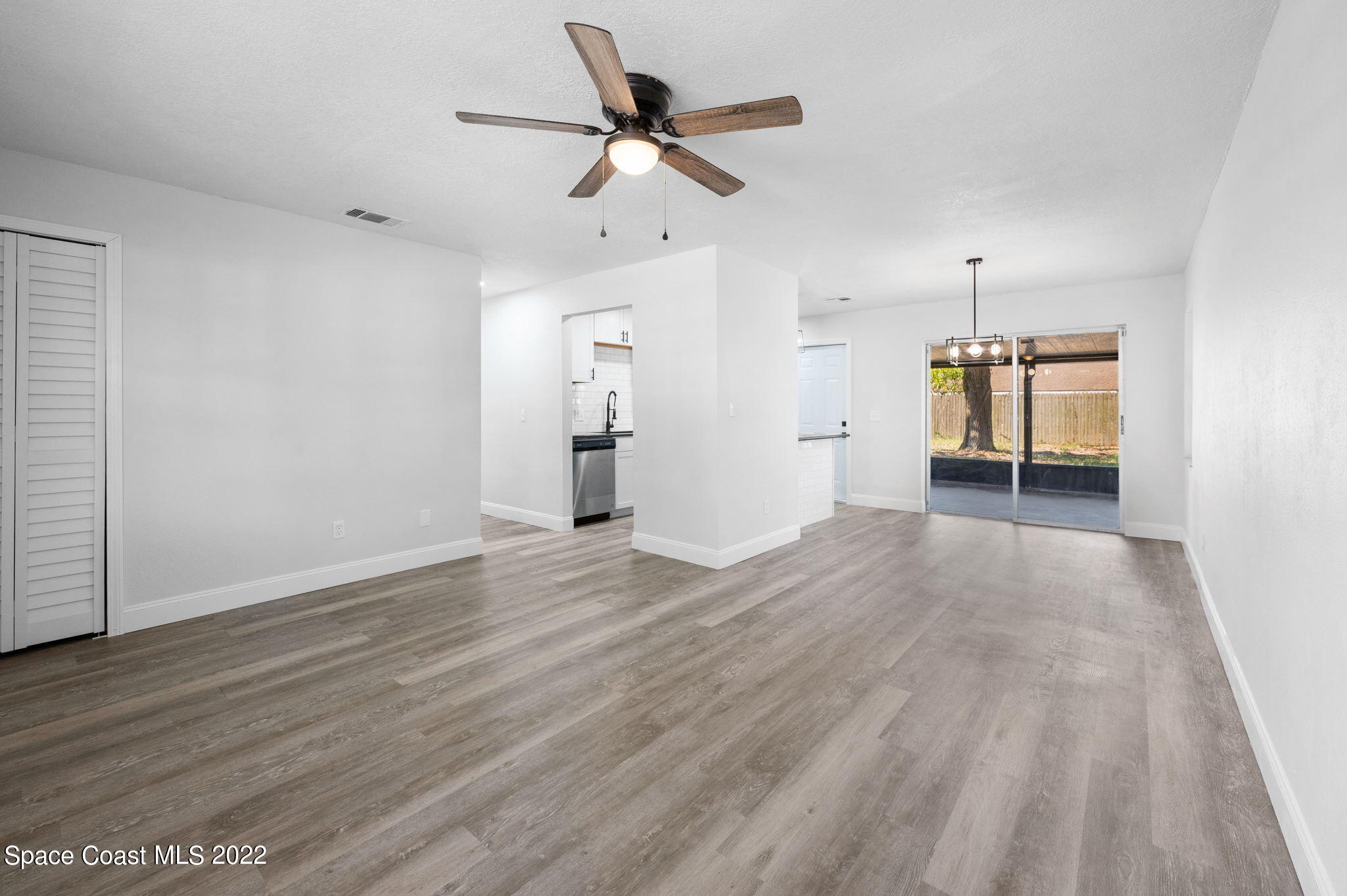 2856 Lancaster Road Melbourne, FL 32935 - Photo 5 of 22 an empty room with wooden floor and ceiling fan