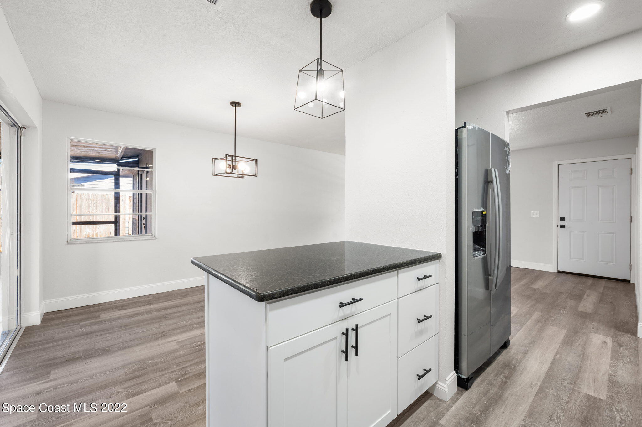 2856 Lancaster Road Melbourne, FL 32935 - Photo 8 of 22 a kitchen with cabinets appliances and a wooden floor
