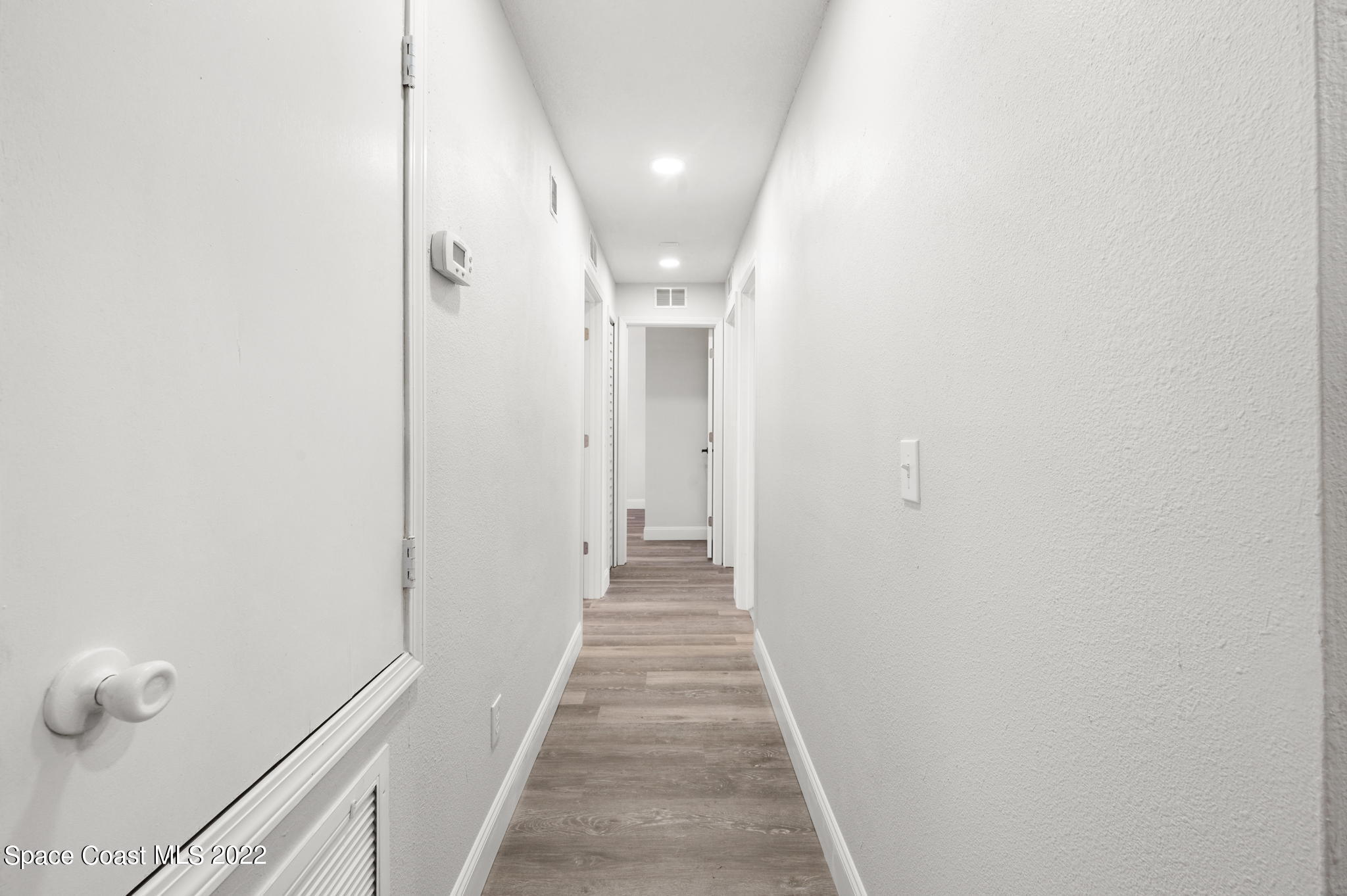 2856 Lancaster Road Melbourne, FL 32935 - Photo 10 of 22 a view of a hallway with wooden floor