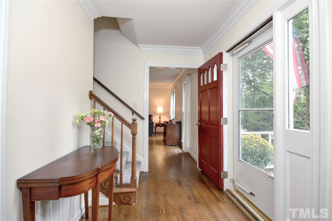 5216 Caber Road Raleigh, NC 27613 - Photo 3 of 25 a view of a hallway with wooden floor stairs