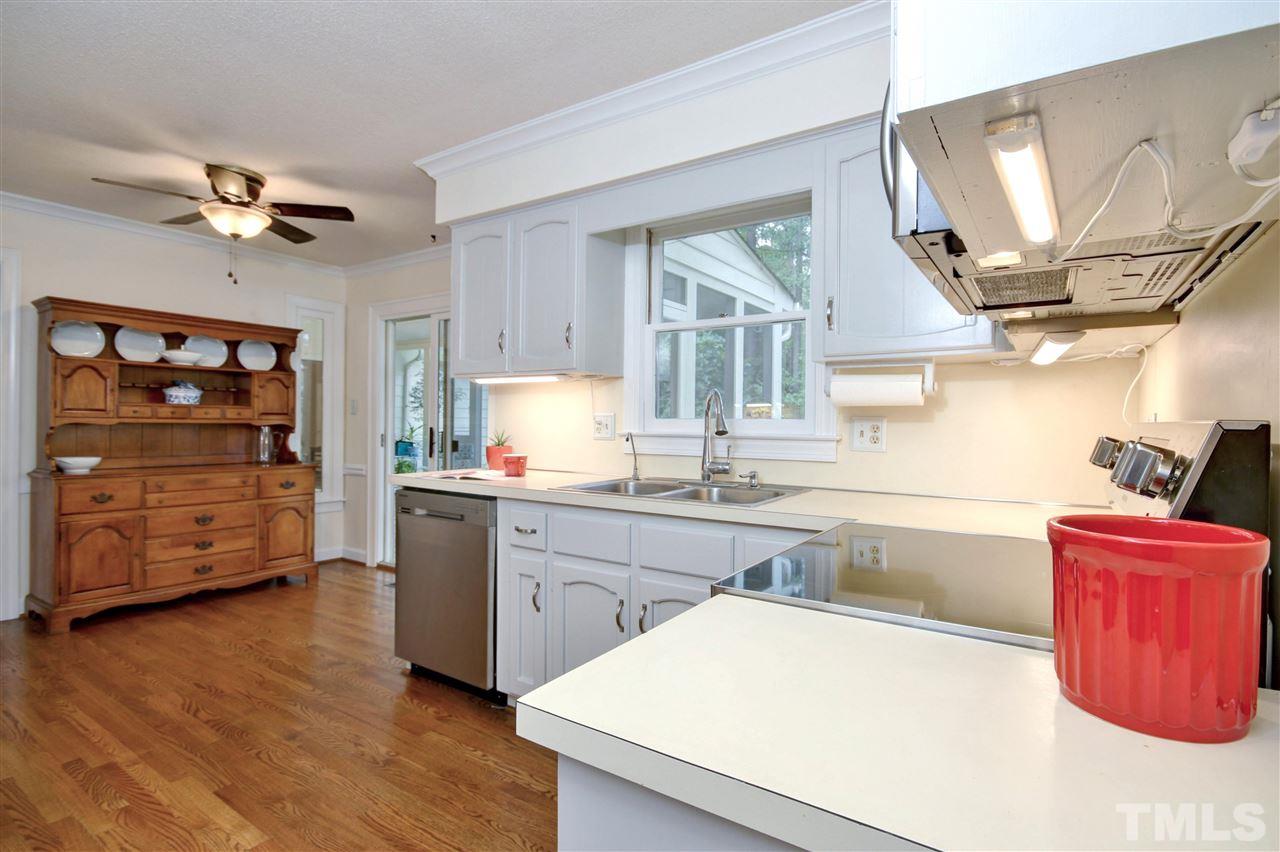 5216 Caber Road Raleigh, NC 27613 - Photo 8 of 25 a kitchen with wooden cabinets and a sink