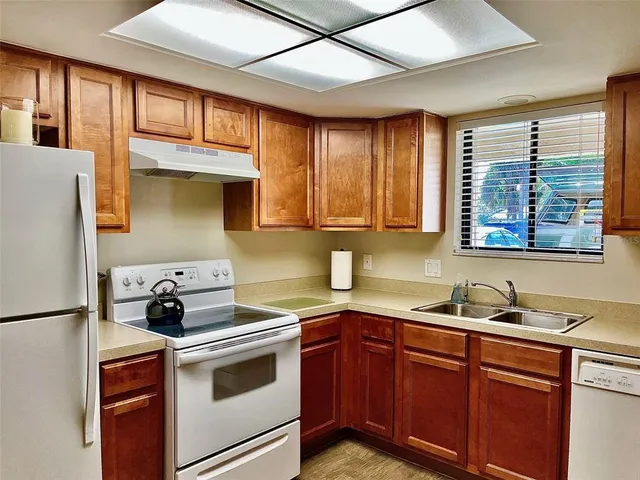 a kitchen with stainless steel appliances a stove a sink and a microwave