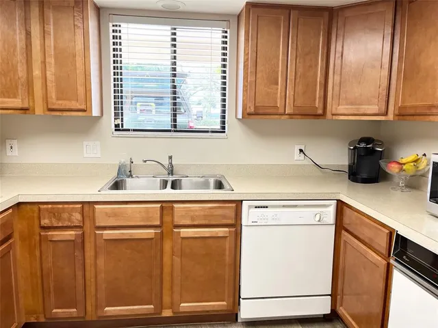 a kitchen with stainless steel appliances granite countertop cabinets and a sink