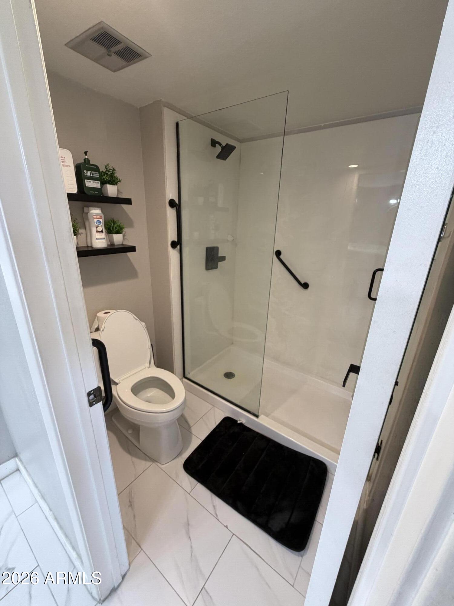 4303 East Cactus Road, Unit 128 Phoenix, AZ 85032 - Photo 31 of 39 a bathroom with a toilet a sink and shower