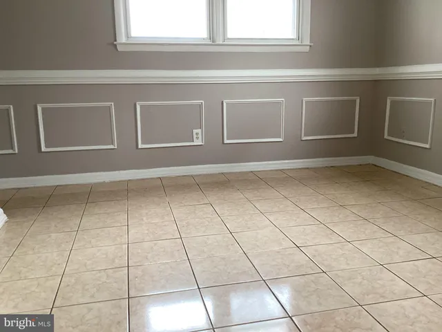 a view of a livingroom with an empty space and a window