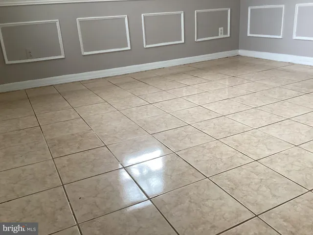 a view of a livingroom with an empty space and a window