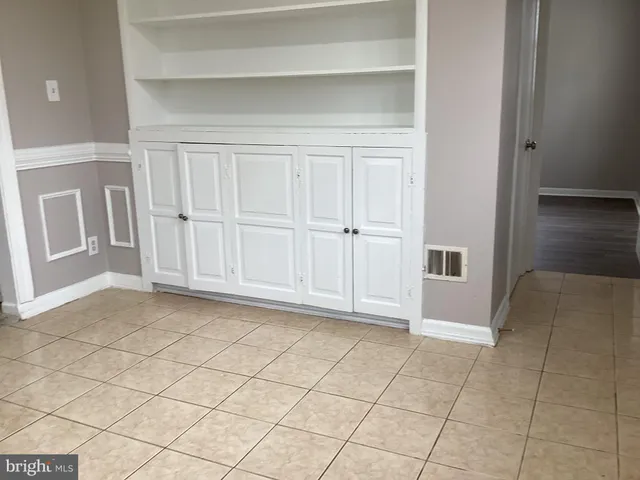 a view of a livingroom with an empty space and wooden floor