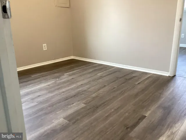 a view of a room with wooden floor