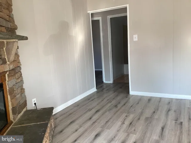 an empty room with wooden floor and closet