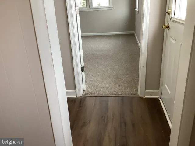 an empty room with wooden floor and a window