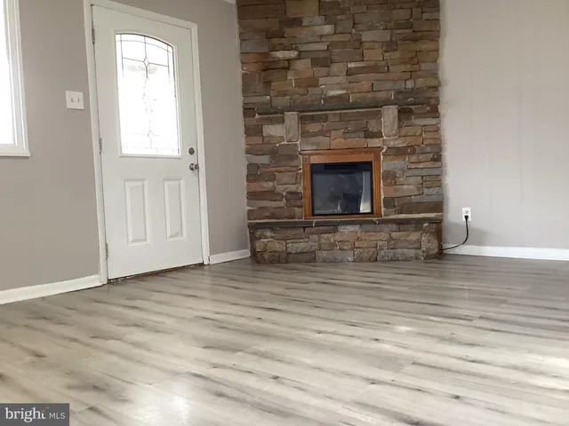 a view of a fireplace with wooden floor