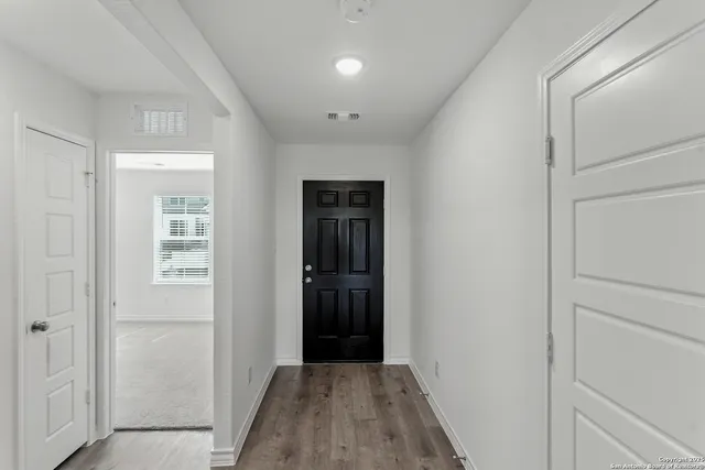 a view of hallway with wooden floor