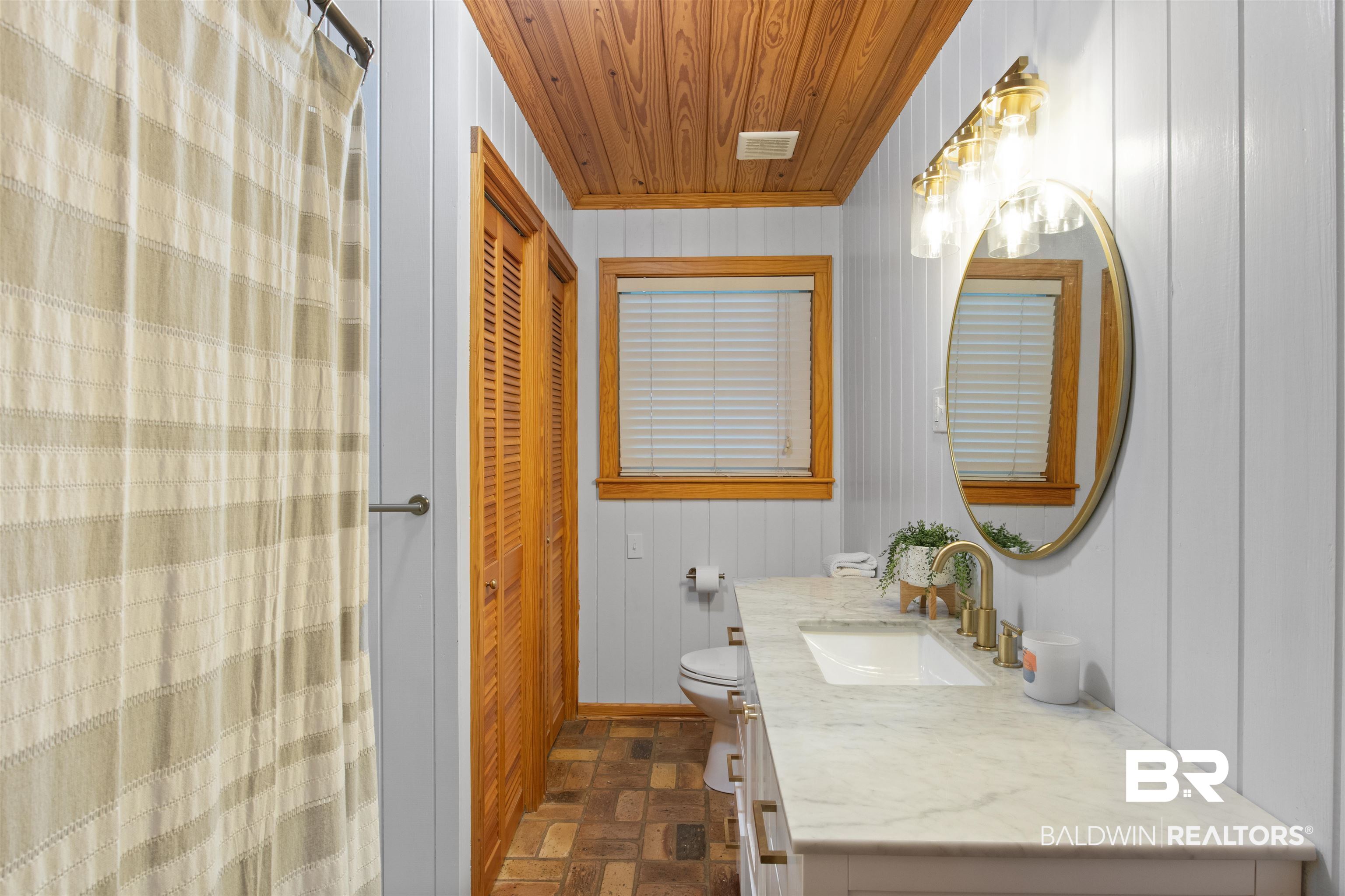 15100 Vasko Road Silverhill, AL 36576 - Photo 23 of 51 Bathroom in hall, ddouble linen closets, wooden ceiling, and vanity.