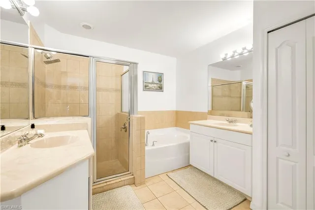 a bathroom with a granite countertop sink mirror bathtub and shower