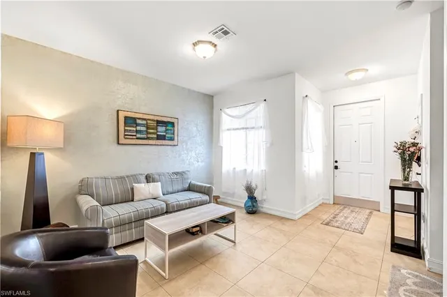 a living room with furniture and a lamp