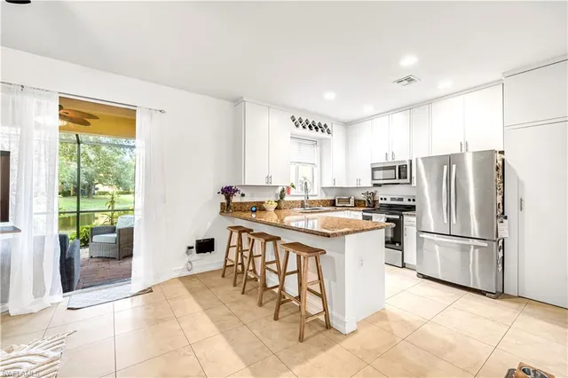 a kitchen with a sink refrigerator and cabinets