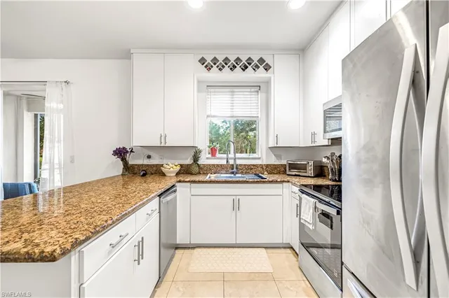 a kitchen with a sink stove and refrigerator