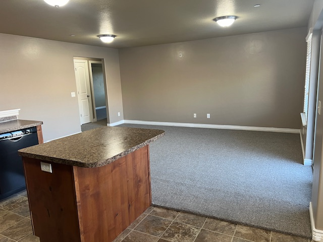917 South Main Street, Unit H Layton, UT 84041 - Photo 6 of 19 Kitchen featuring dark countertops, black dishwasher, and dark carpet
