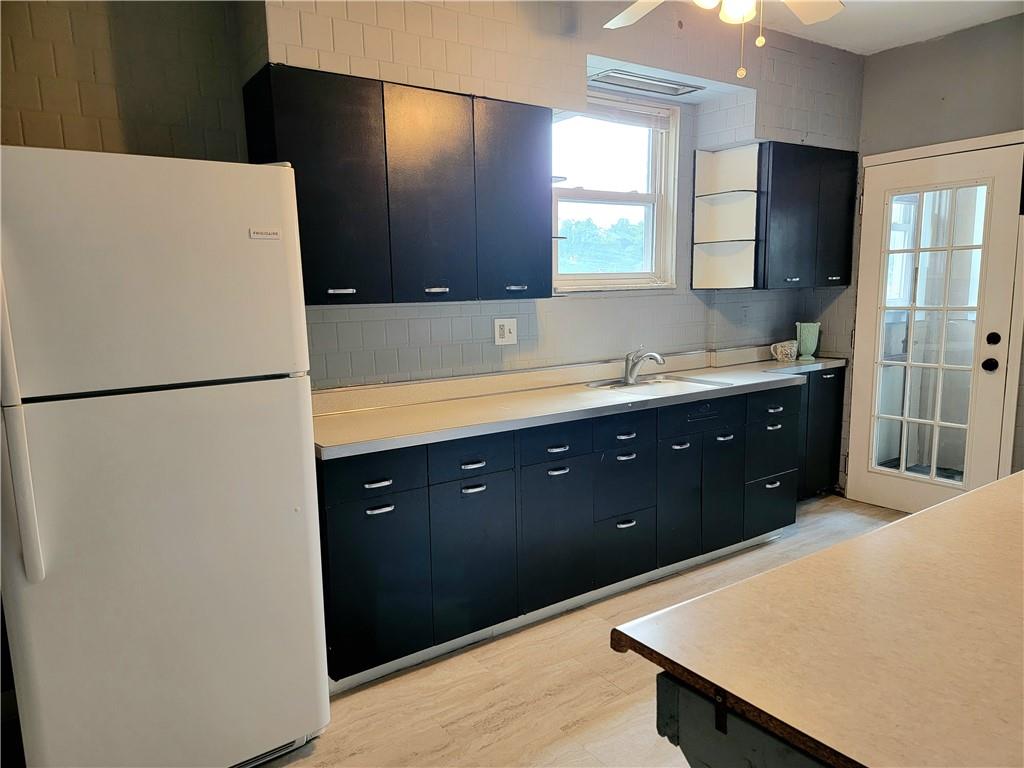 1128 Wayne Avenue McKees Rocks, PA 15136 - Photo 8 of 24 a kitchen with stainless steel appliances a refrigerator and a sink