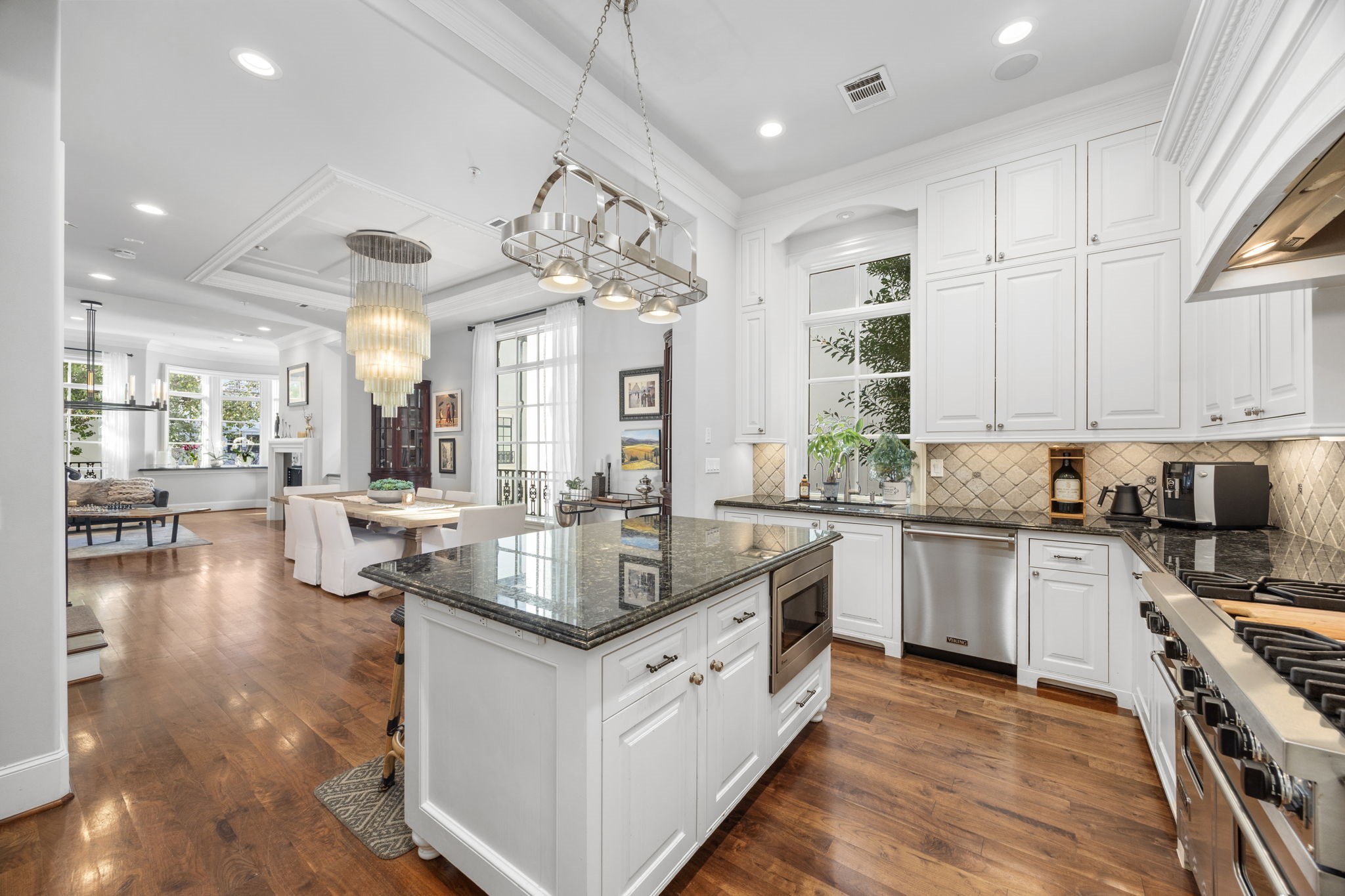 1723 Sunset Boulevard Houston, TX 77005 - Photo 16 of 50 The gourmet kitchen makes a striking impression with floor-to-ceiling custom cabinetry, polished stone countertops, and a layout designed for both everyday living and entertaining.