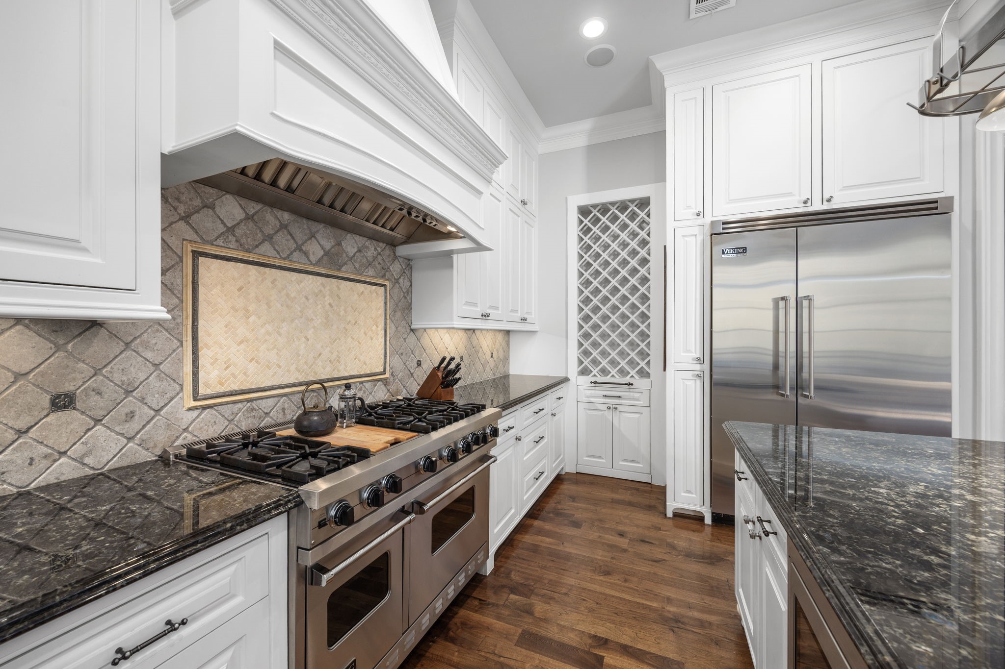 1723 Sunset Boulevard Houston, TX 77005 - Photo 18 of 50 Professional-grade Viking stainless steel appliances elevate the kitchen’s performance, blending high-end function with timeless design.