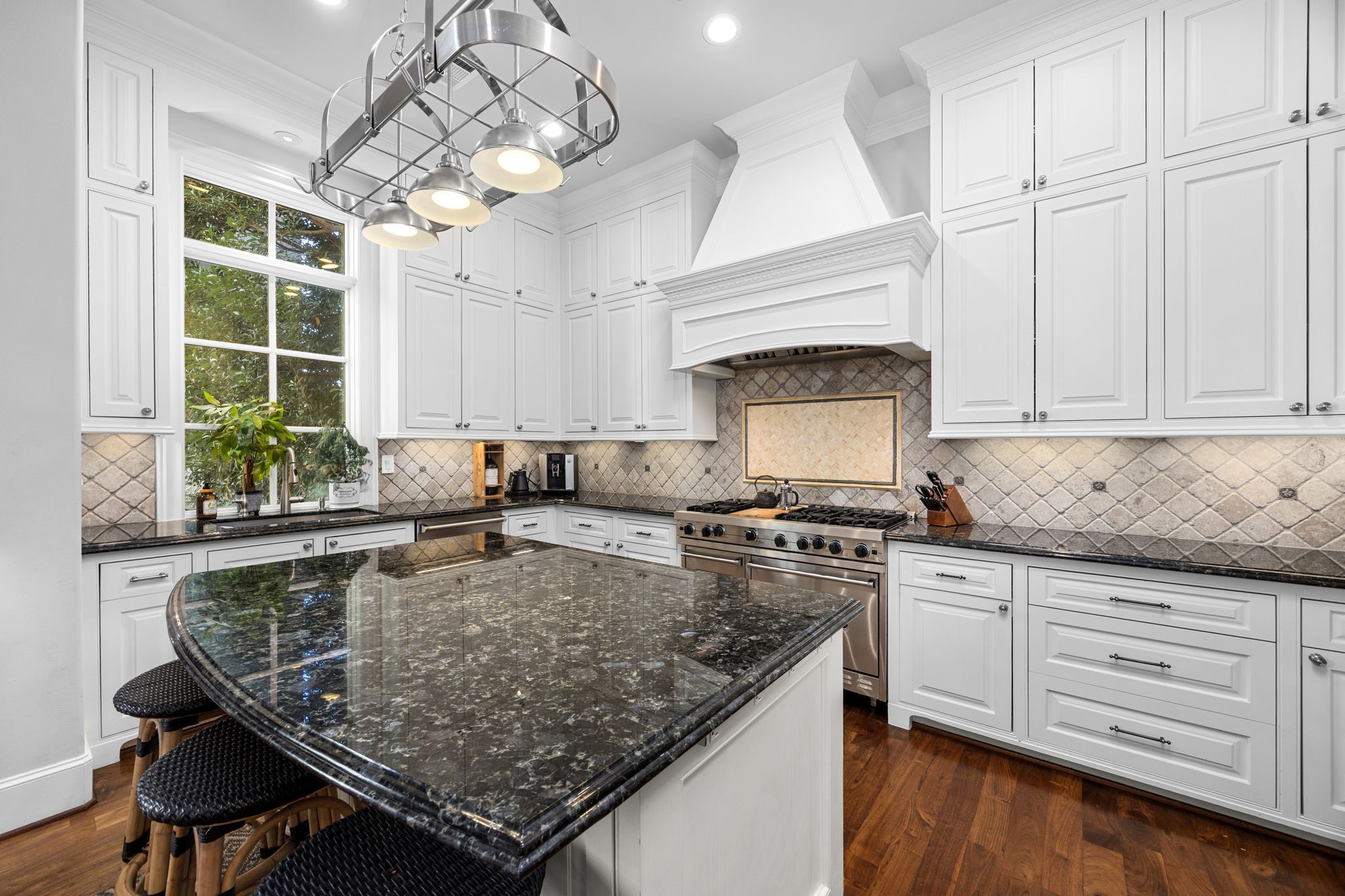 1723 Sunset Boulevard Houston, TX 77005 - Photo 20 of 50 A generous center island anchors the space, offering ample prep room, seating for casual meals, and a natural gathering point for guests.