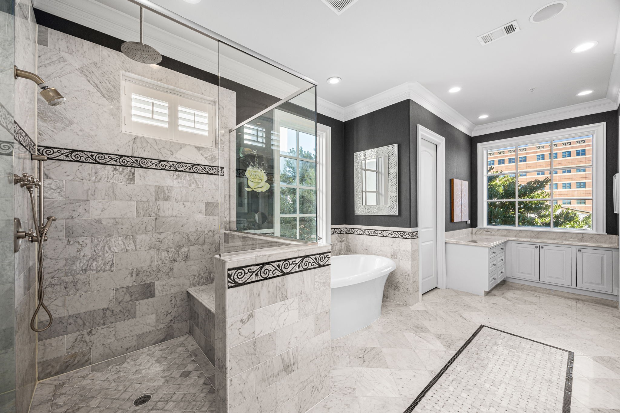 1723 Sunset Boulevard Houston, TX 77005 - Photo 26 of 50 The primary bath feels spa-inspired with premium stone surfaces, a spacious walk-in shower, and a calming, refined aesthetic.
