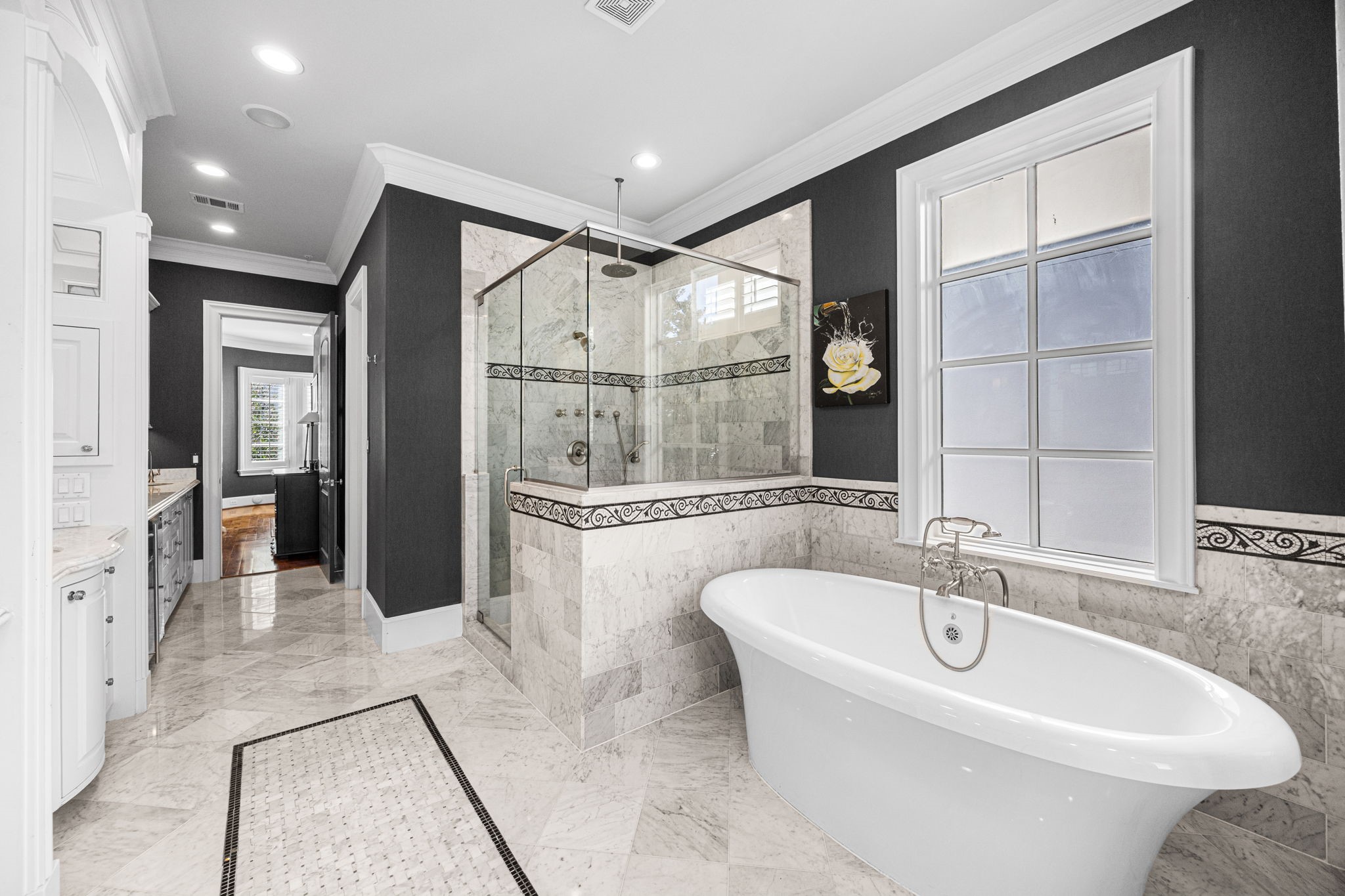 1723 Sunset Boulevard Houston, TX 77005 - Photo 27 of 50 A freestanding soaking tub creates a striking focal point, offering a relaxing escape paired with elegant finishes and soft natural light.