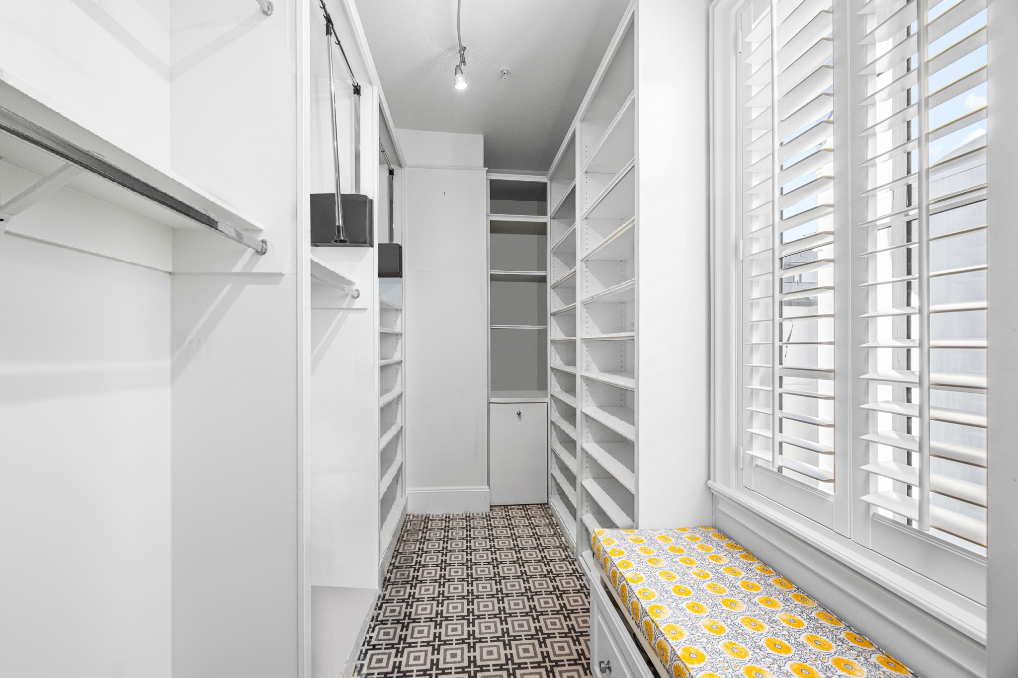 1723 Sunset Boulevard Houston, TX 77005 - Photo 30 of 50 One of two custom walk-in closets is beautifully designed with built-in shelving, drawers, and hanging space for effortless organization. This photo has been virtually staged.